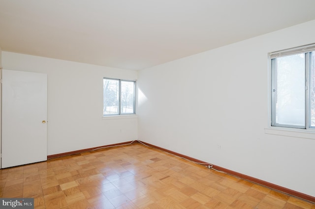 unfurnished room featuring baseboards