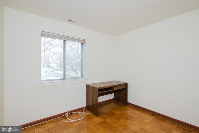 spare room featuring baseboards and visible vents