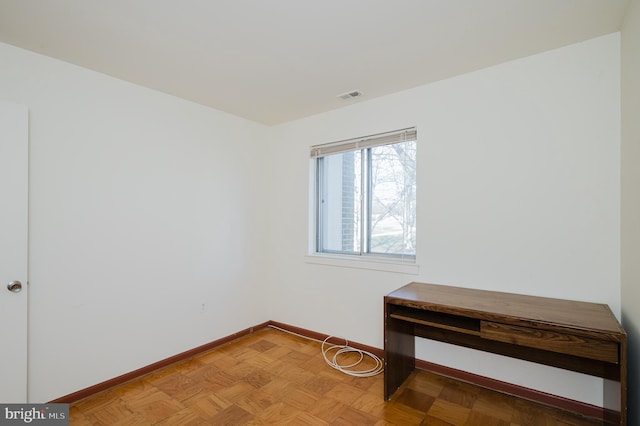 spare room with baseboards and visible vents