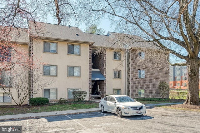 view of building exterior featuring uncovered parking