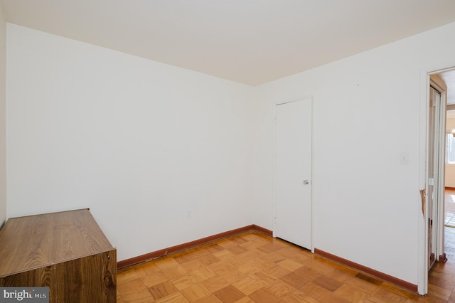 spare room featuring baseboards