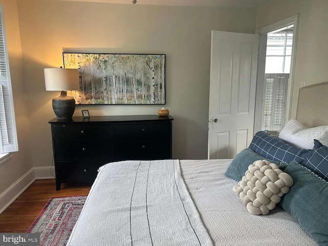 bedroom featuring baseboards and wood finished floors