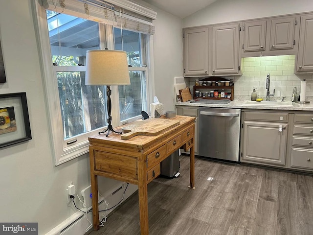 kitchen with stainless steel dishwasher, a sink, decorative backsplash, light countertops, and gray cabinets