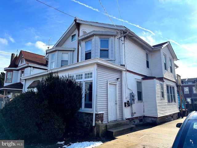 view of side of home featuring entry steps
