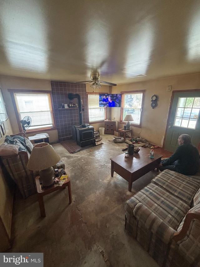 526 Bainbridge Ave, Mays Landing, NJ 08330 - living area featuring a wealth of natural light, a wood stove, concrete flooring, and a ceiling fan