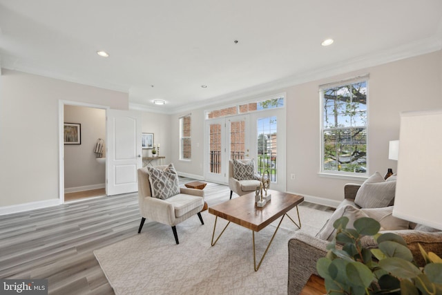 living area featuring recessed lighting, light wood finished floors, baseboards, and ornamental molding