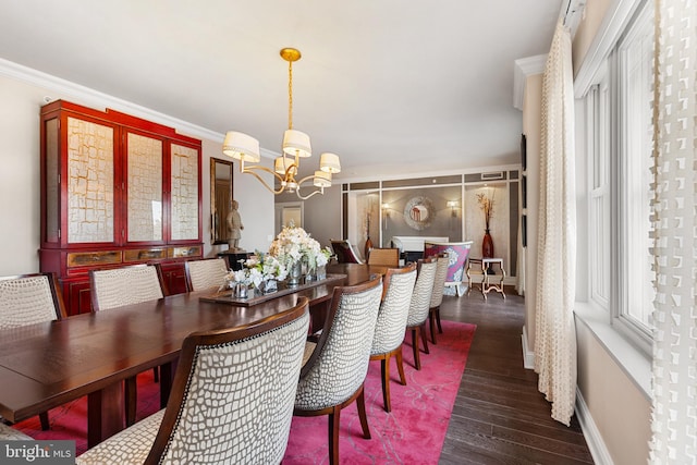 dining area featuring crown molding, baseboards, a chandelier, and dark wood finished floors