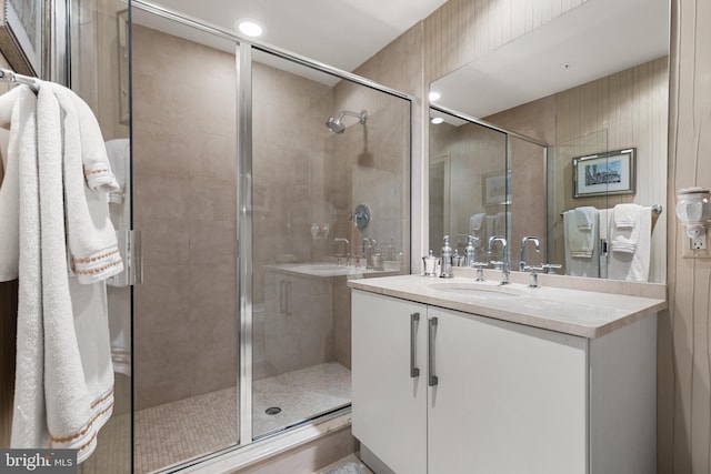 full bath with a shower stall and vanity