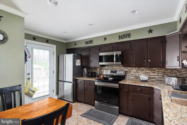 kitchen featuring stainless steel appliances, dark brown cabinetry, backsplash, and ornamental molding