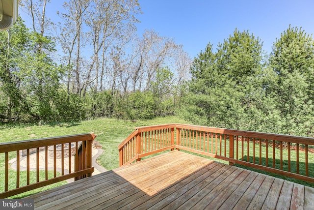 wooden deck with a lawn