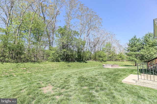 view of yard with an outdoor fire pit and a patio