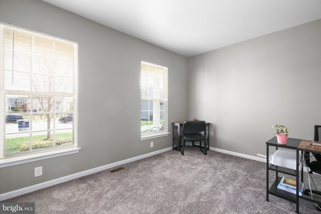 office area with visible vents, baseboards, and carpet floors