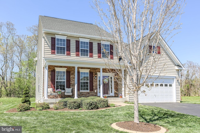 view of front facade featuring aphalt driveway, a porch, a front lawn, an attached garage, and a shingled roof