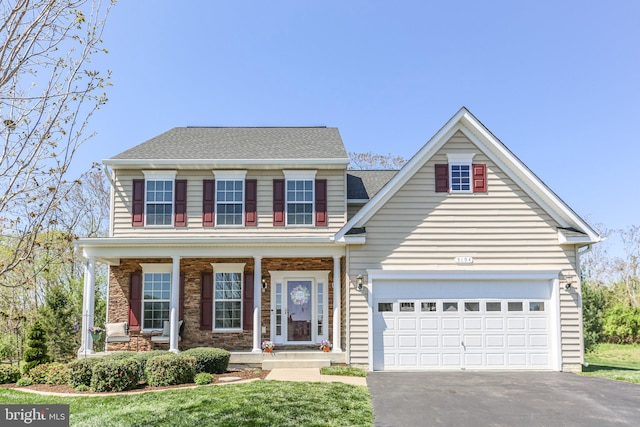 traditional-style house with stone siding, aphalt driveway, a porch, a garage, and a shingled roof
