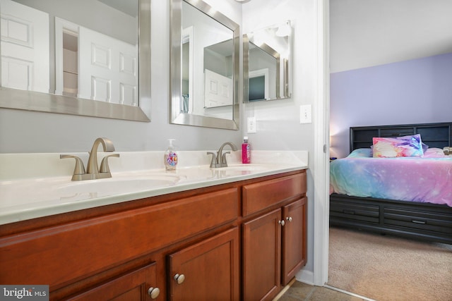 bathroom featuring double vanity, a sink, and connected bathroom