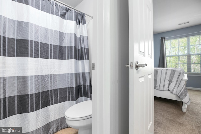 full bath with a shower with shower curtain, visible vents, baseboards, and toilet