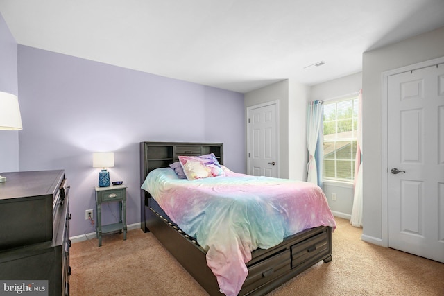 carpeted bedroom with baseboards and visible vents
