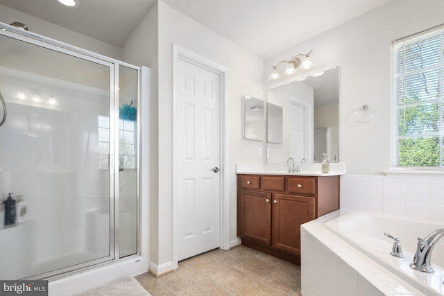 full bathroom featuring baseboards, a garden tub, a stall shower, and vanity