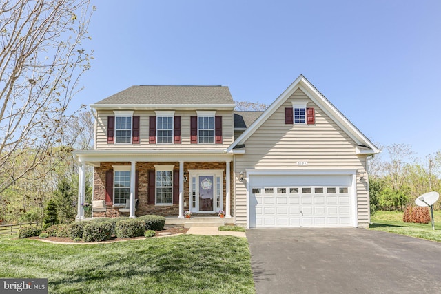 view of front of home with a porch, stone siding, a garage, aphalt driveway, and a front lawn