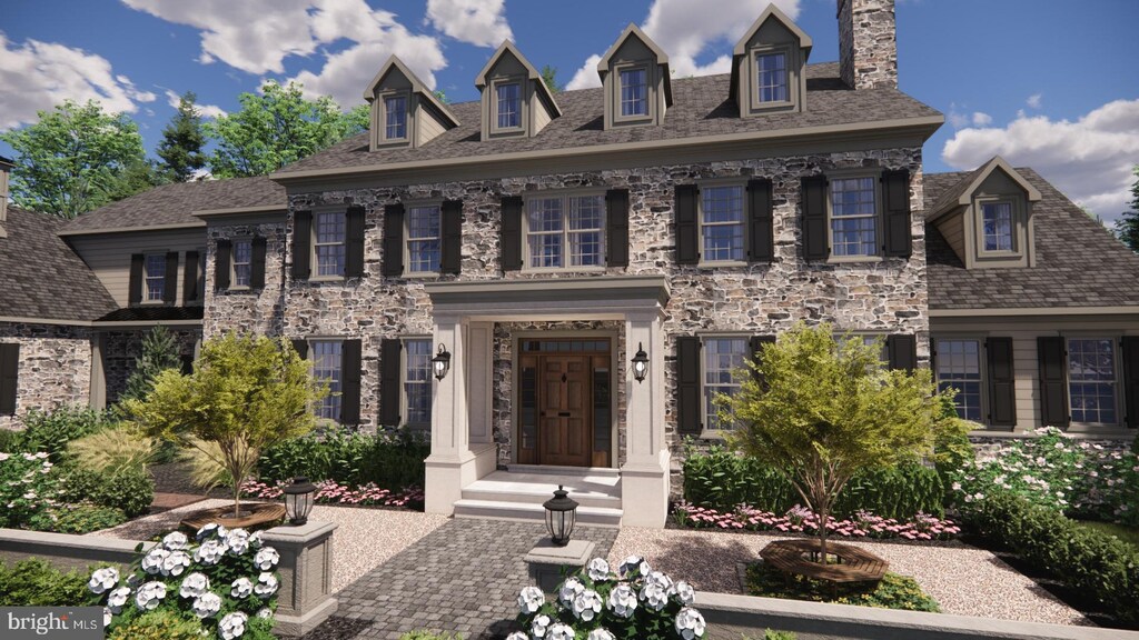 colonial house featuring a chimney and stone siding