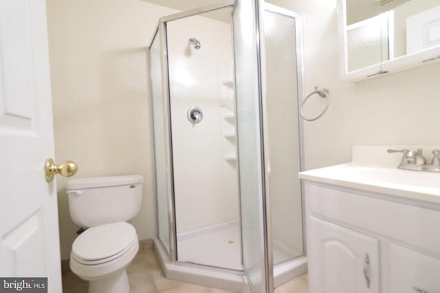 bathroom with toilet, vanity, and a shower stall