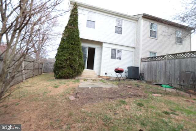 back of house with cooling unit, entry steps, and a fenced backyard
