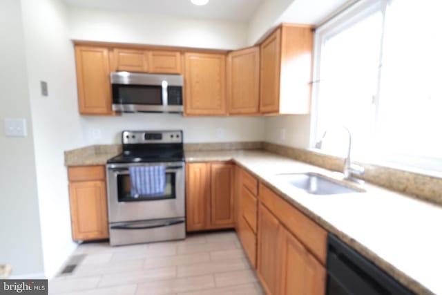 kitchen featuring a sink, light countertops, and appliances with stainless steel finishes