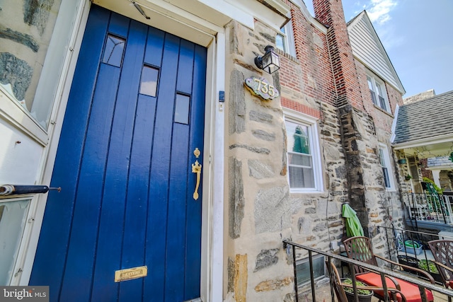 entrance to property featuring stone siding