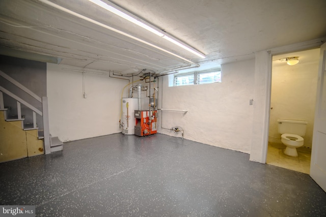 basement featuring a heating unit, stairway, and gas water heater
