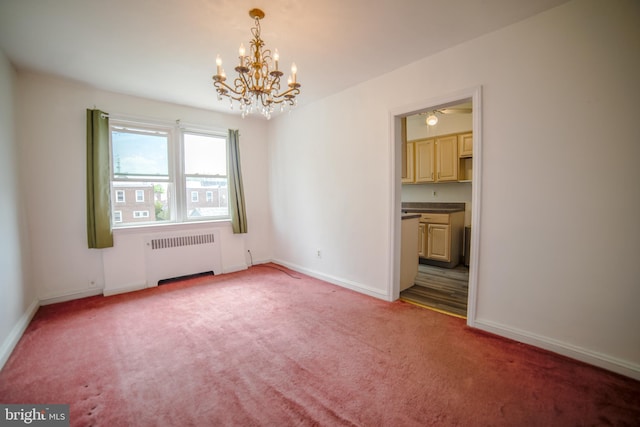 empty room featuring radiator, an inviting chandelier, baseboards, and light colored carpet