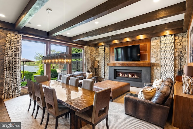 dining room featuring recessed lighting, wood finished floors, a fireplace, and beamed ceiling