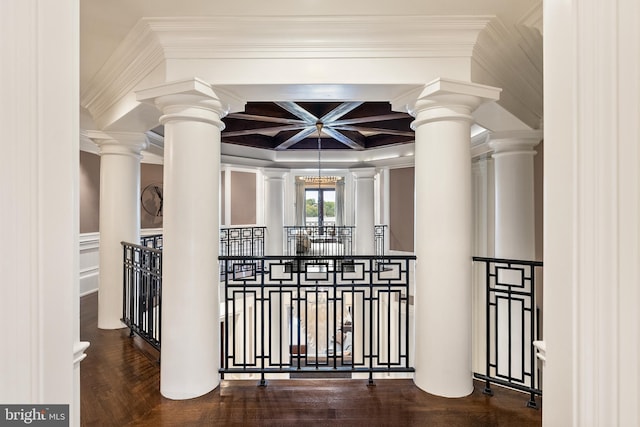 interior space with ornate columns, ornamental molding, coffered ceiling, and an upstairs landing