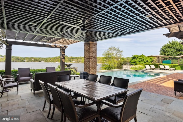 view of patio / terrace featuring a pergola, a water view, outdoor dining area, and an outdoor pool