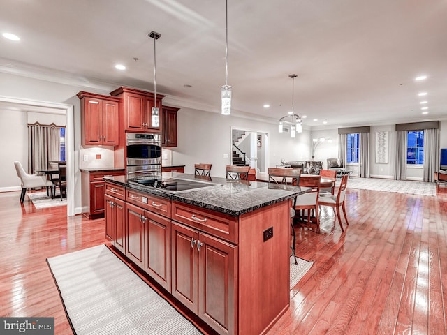 6 Paladia Way, Pikesville, MD 21208 - kitchen with black electric cooktop, a kitchen island, double oven, light wood-type flooring, and open floor plan
