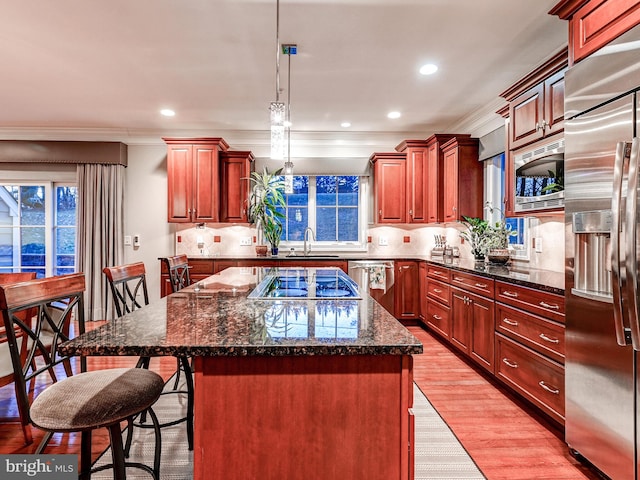 6 Paladia Way, Pikesville, MD 21208 - kitchen with light wood finished floors, a sink, a breakfast bar area, built in appliances, and a center island