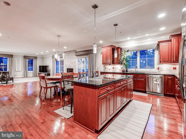 6 Paladia Way, Pikesville, MD 21208 - kitchen with stainless steel dishwasher, open floor plan, light wood-style floors, and decorative backsplash