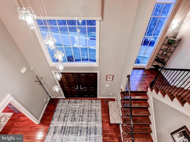 6 Paladia Way, Pikesville, MD 21208 - foyer featuring plenty of natural light, a notable chandelier, wood finished floors, and stairway