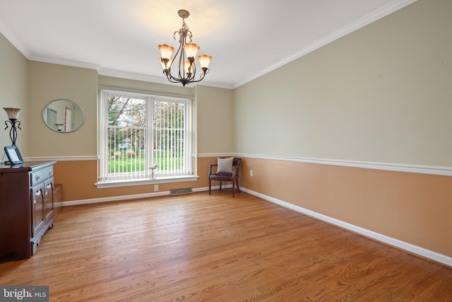 unfurnished dining area with baseboards, light wood-style floors, a notable chandelier, and ornamental molding