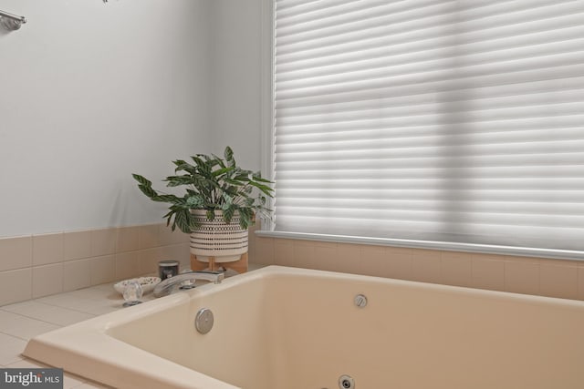 full bathroom with a tub with jets