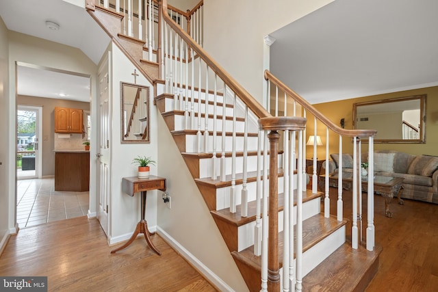 stairs with baseboards and wood finished floors