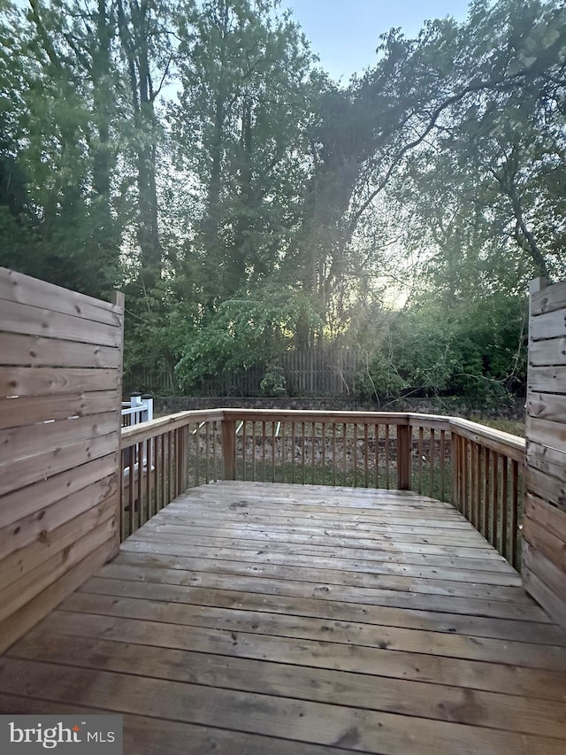 wooden terrace featuring a fenced backyard