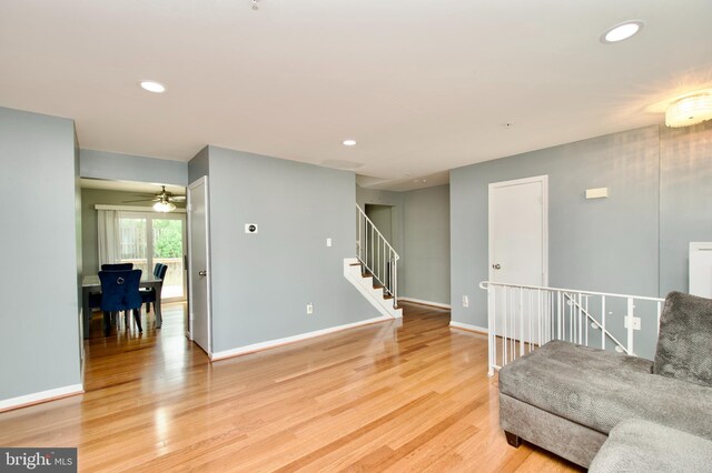 living room featuring recessed lighting, baseboards, ceiling fan, and light wood finished floors