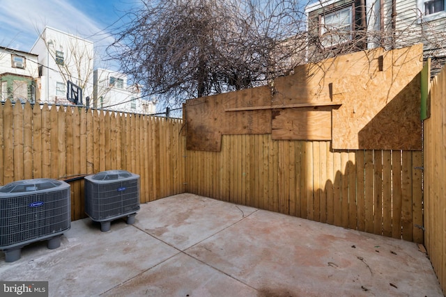 view of patio with cooling unit and fence