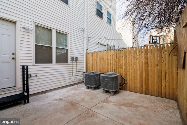 view of patio featuring cooling unit and fence