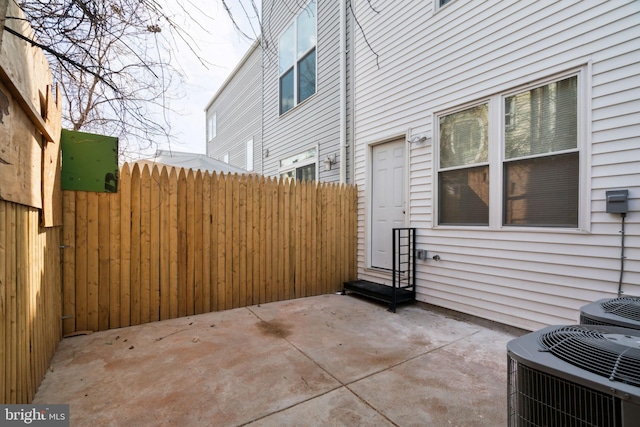 view of patio / terrace featuring central air condition unit, entry steps, and fence