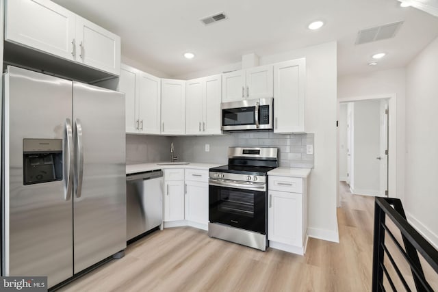 kitchen with light countertops, visible vents, white cabinets, and appliances with stainless steel finishes