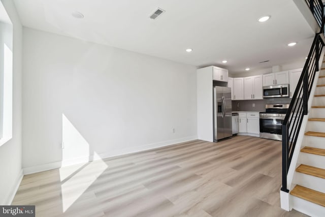 kitchen featuring white cabinets, visible vents, recessed lighting, appliances with stainless steel finishes, and light wood-type flooring