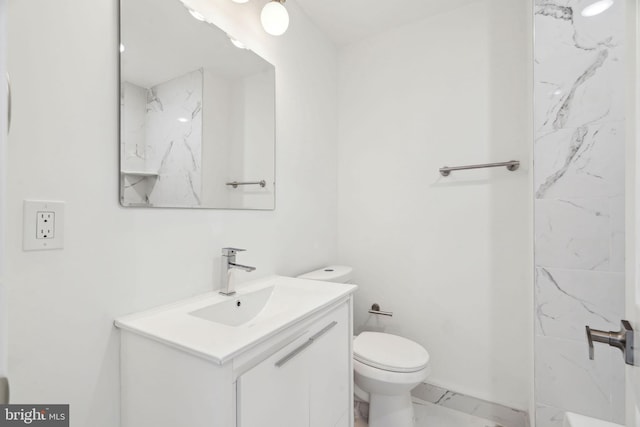bathroom featuring marble finish floor, vanity, and toilet