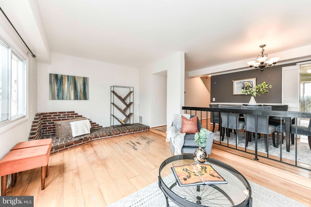living area featuring a notable chandelier and wood finished floors