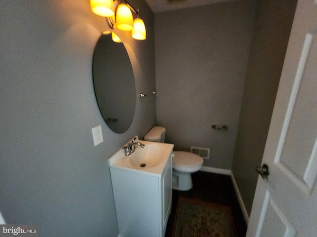 528 N Montford Ave, Baltimore, MD 21205 - half bathroom featuring baseboards, visible vents, toilet, and vanity